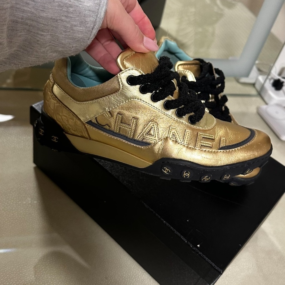 Black and gold Chanel sneakers